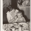 Wife of unemployed oil worker feeding her baby. Seminole, Oklahoma