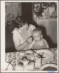 Wife of unemployed oil worker feeding her baby. Seminole, Oklahoma