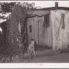 Young son of unemployed oil worker sitting on front porch of home. Seminole, Oklahoma