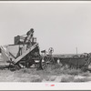 Old combine which has not been used for several years. Gray County, Kansas