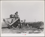 Old combine which has not been used for several years. Gray County, Kansas