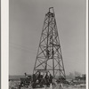 Lifting casing upon the derrick to finish a water well for irrigation purposes on farm near Garden City, Kansas