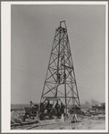 Lifting casing upon the derrick to finish a water well for irrigation purposes on farm near Garden City, Kansas