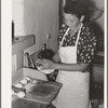 Tortillas being shaped after they have been rolled flat. Spanish-American home near Taos, New Mexico, Taos County