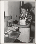 Tortillas being shaped after they have been rolled flat. Spanish-American home near Taos, New Mexico, Taos County