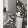 Shaping dough into balls before rolling out tortillas. Spanish-American home near Taos, New Mexico, Taos County