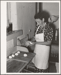 Shaping dough into balls before rolling out tortillas. Spanish-American home near Taos, New Mexico, Taos County