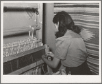 Spanish-American girl threading the loom at WPA (Works Progress Administration/Work Projects Administration) weaving project. Costilla, New Mexico
