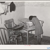 Spanish-American girl washing her face. Farm home near Taos, New Mexico