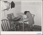 Spanish-American girl washing her face. Farm home near Taos, New Mexico