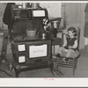 Sitting by the kitchen stove on a cold autumn day in New England. Near Bradford, Vermont, Orange County