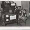 Sitting by the kitchen stove on a cold autumn day in New England. Near Bradford, Vermont, Orange County