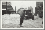 Snow removal on Flatbush Avenue in Brooklyn, near the L.I.R.R. station (at right)