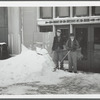 Mr. Carl Anderson and Mr. Krashewsky clearing snow in front of the Ex-Lax building