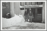 Mr. Carl Anderson and Mr. Krashewsky clearing snow in front of the Ex-Lax building