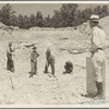 Farmers resettled on Skyline Farms, Alabama, at work in sand quarry under supervision of project manager