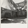 An Indian woman in front of her tepee. Many Indians on the Mescalero Reservation in New Mexico live in such primitive tents