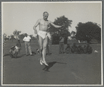 Ted Shawn dancing outdoors in midair jump as Delissaville residents watch


