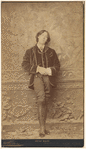 Full-length portrait photograph of Oscar Wilde, matted and framed