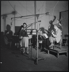 Jazz guitarist Mary Osborne in a recording session for Decca Records, featuring Hy White, guitar; Burt Blake, bass; Cliff Leeman, drums; Jack Pleis, piano