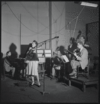 Jazz guitarist Mary Osborne in a recording session for Decca Records, featuring Hy White, guitar; Burt Blake, bass; Cliff Leeman, drums; Jack Pleis, piano