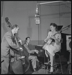 Jazz guitarist Mary Osborne in a recording session for Decca Records, featuring Burt Blake, bass; and Jack Pleis, piano