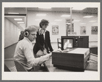 Betty Corwin, director of the Theatre on Film and Tape Archive, and Richard Ryan, technical assistant, reviewing a videotaping of the stage production Amadeus