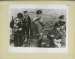 One of the first U-boats to surrender... under the guard of Polish sailors... (Accompanying text on opposite leaf).