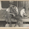 Sharecropper and child on porch of company house. Arkansas. 1935