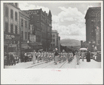 High school band parading up Montana Street, Butte, Montana
