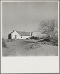 Shifting drifts of dust will soon force this farmer to abandon his home near Liberal, Kansas