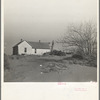 Shifting drifts of dust will soon force this farmer to abandon his home near Liberal, Kansas