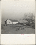 Shifting drifts of dust will soon force this farmer to abandon his home near Liberal, Kansas