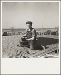 A farmer's son playing on one of the large soil drifts which threaten to cover up his home. Liberal, Kansas