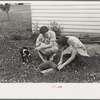 Housewives killing a chicken for dinner, Decatur Homesteads, Indiana