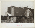 Squatters' shacks with grain elevator in background, Saint Louis, Missouri