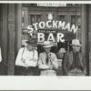 Stockmen in front of bar on main street, Miles City, Montana