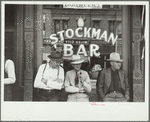 Stockmen in front of bar on main street, Miles City, Montana