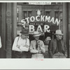 Stockmen in front of bar on main street, Miles City, Montana