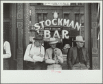 Stockmen in front of bar on main street, Miles City, Montana
