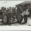 Farmer inspects a cultivator, Central Iowa 4-H Club fair, Marshalltown, Iowa