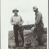 Farmer and son with sack of potatoes, Rio Grande County, Colorado