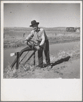 Opening gate leading from Rio Grande, conserving canal in order to irrigate field. Dona Ana County, New Mexico