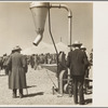 Farmers inspecting new machinery at a farm implement demonstration. Carson County, Texas