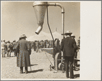 Farmers inspecting new machinery at a farm implement demonstration. Carson County, Texas