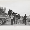 State highway officials moving evicted sharecroppers away from roadside to area between the levee and the Mississippi River, New Madrid County, Missouri