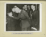 Oldest soldier talking to the youngest one.