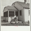 Farmsteader's wife painting kitchen furniture. Falls City Farmsteads, Nebraska