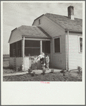 Farmsteader's wife painting kitchen furniture. Falls City Farmsteads, Nebraska