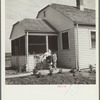 Farmsteader's wife painting kitchen furniture. Falls City Farmsteads, Nebraska